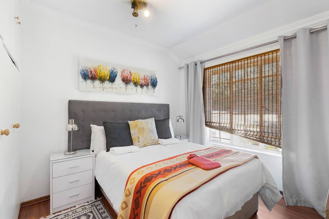 Bedroom with a grey upholstered headboard
